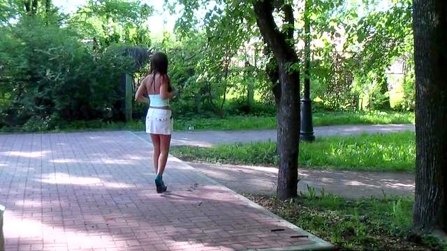 Brunette in white dress shows off her ass in the public