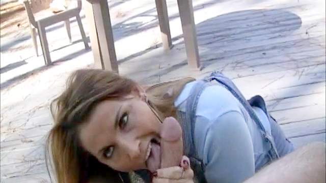 Lovely redhead blows a dick outdoors