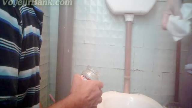 Perverted babe is peeing in the toilet