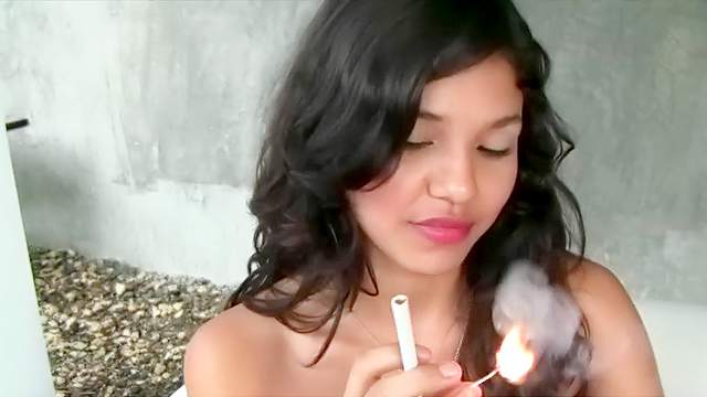 Asian babe is smoking a cigarette so hot