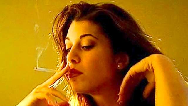 Sexy brunette has a cigarette
