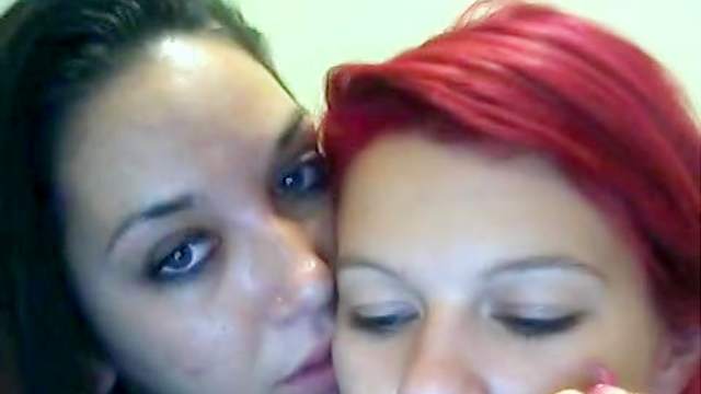Brunette and redhead lesbians get kinky on webcam