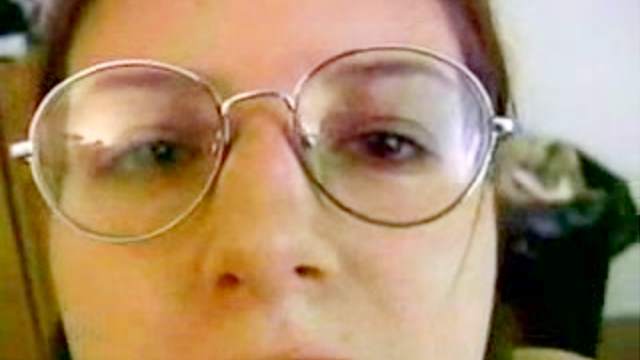 Pigtailed brunette in glasses is masturbating