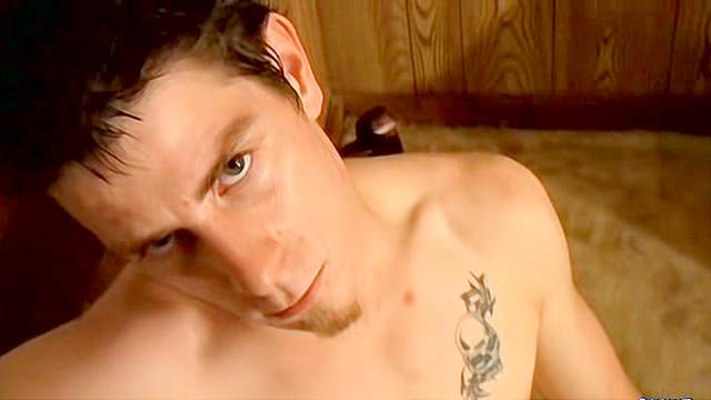 Dark-haired guy with tattoos masturbates on a chair
