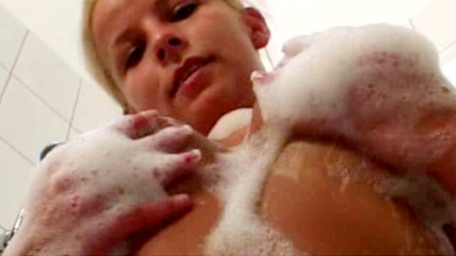 Soapy blonde Lucy touches her shaved pussy