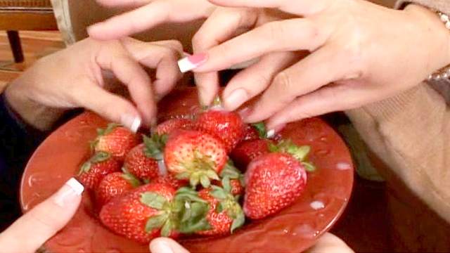 Three glamorous ladies are eating fruits