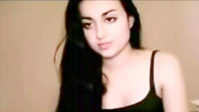 Dark-haired brunette poses on the webcam