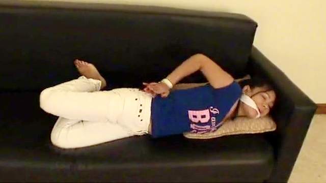 Bonded Asian chick is lying on sofa