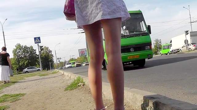 Young girl in sexy dress filmed outdoor upskirt