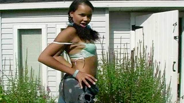Sexy ebony Kimberley is posing on the backyard