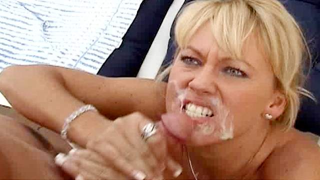 Tanned blonde is getting cum on her lips