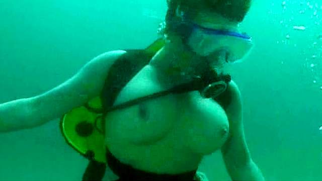 Busty girl having underwater sex with her man