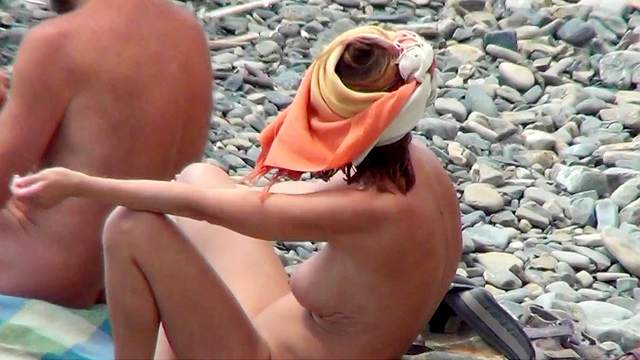 Voyeur scene with busty babes on the beach