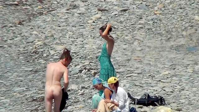 Sexy nudists are walking in the sea