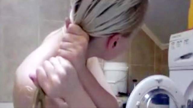 Blonde is washing her boobies and shaved puss