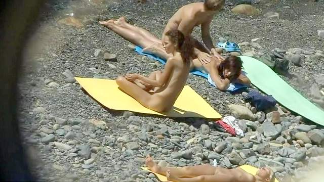 Sweet lady is getting naked on the beach
