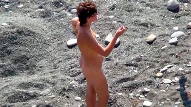 Sexy nudist is getting naked on the beach