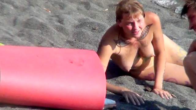 MILF nudist is getting naked on the beach