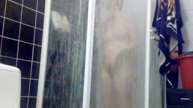 Voyeur view of showering girl