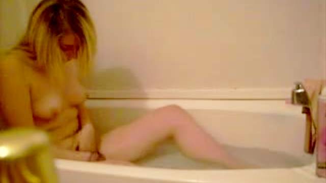 Cute teenager masturbates in bathtub