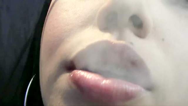 Thick lips girl smokes a cigarette