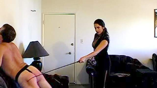 Bent over guy caned by his mistress