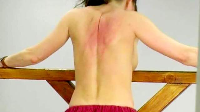 Topless women in whipping video
