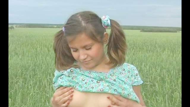 Lovely teen Albina fingering her pussy in the grass field