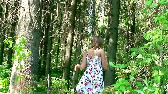 Slutty and curious brunette with long hair is pissing in the forest