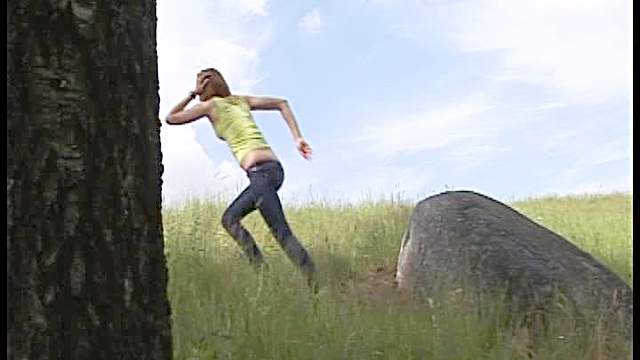 Pretty girl pisses on a rock