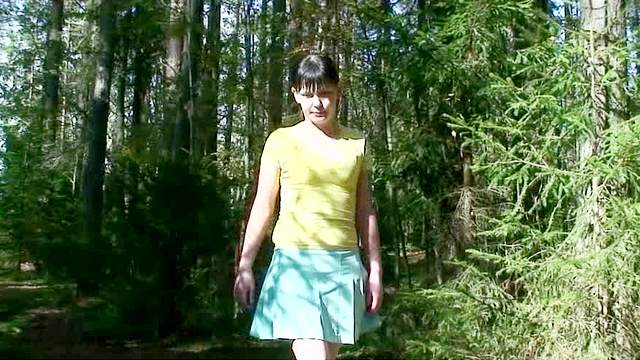 Girl in a short skirt pees outside