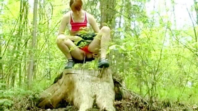 Redhead in short skirt pissing outdoors