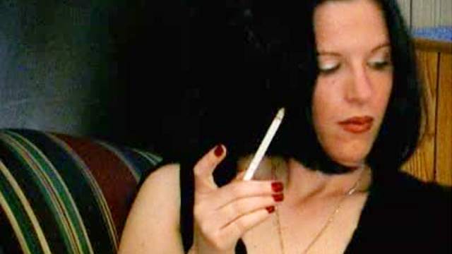 Pretty girl smokes cigarette sensually
