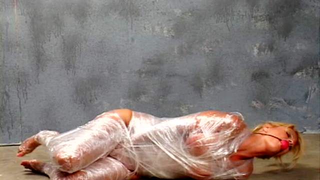 Plastic wrapped girl masturbates pussy