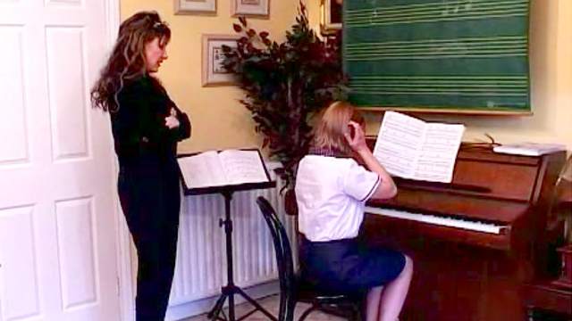 Piano teacher spanks her student hard