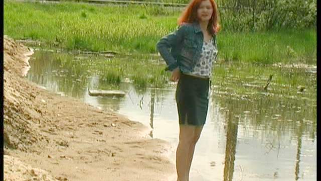 Redhead goes piss in the sand