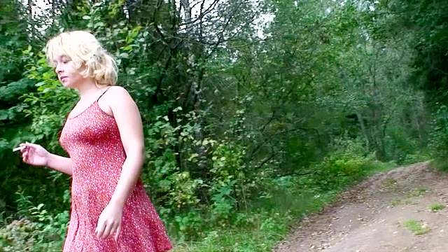 Young girl in a dress pisses outdoors