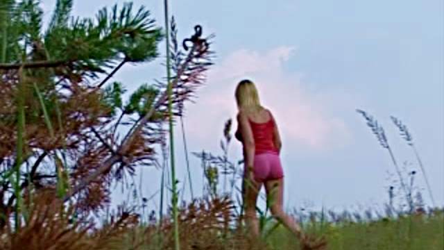 Girl in a field has a hot piss