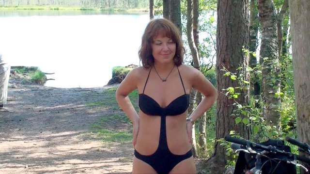 Teen poses by the the lake in a swimsuit