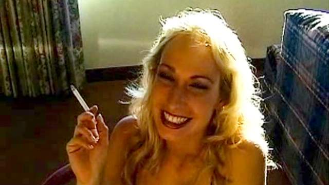 Smoking girl smiles in erotic video