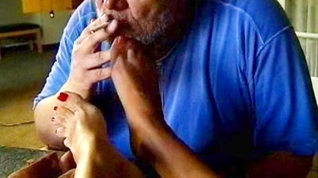 He smokes and sucks her toes in stockings