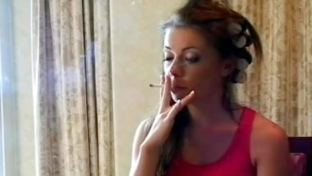 Sweet brunette teen is smoking cigarette