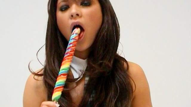 Curly brunette Natalia Forrest is sucking tasty candy