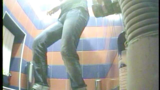 Innocent brunette shows off her long legs in the toilet