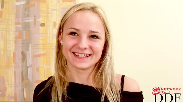 Smiling blonde Claudie takes off her blouse