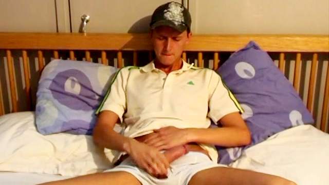 Perverted dude is sitting and masturbating his cock