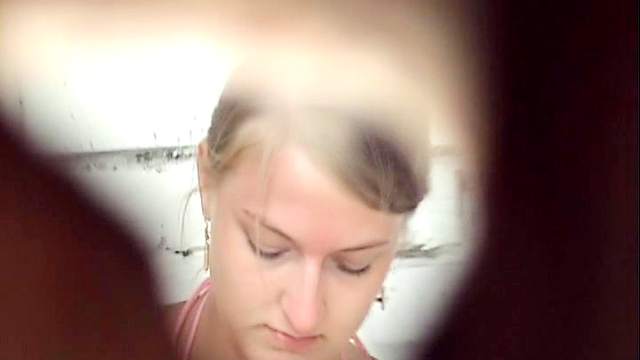 Sensual blonde is peeing through the hole