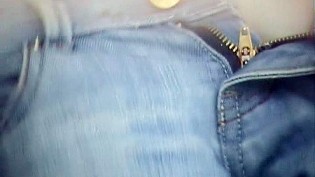 Sexy babe is peeing through the hole in the wall